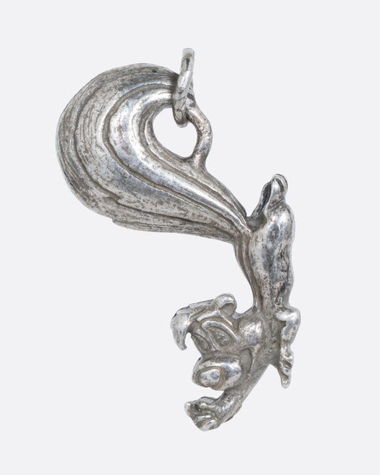 A silver Pepe Le Pew charm. Shown from the front.