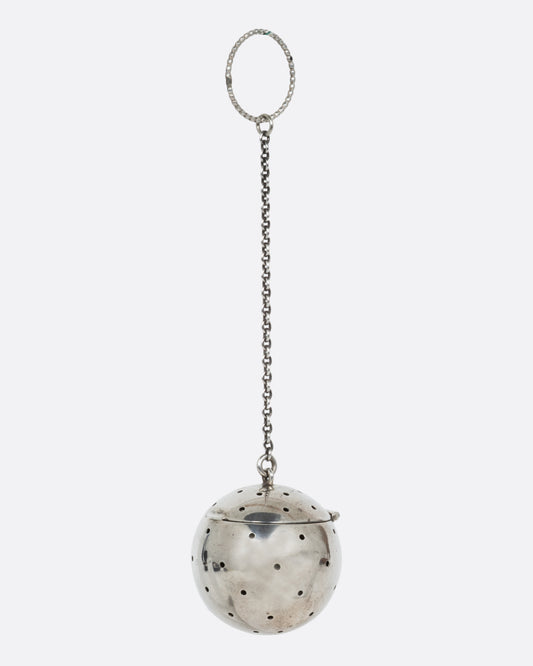 A silver spherical tea infuser topped with a hinged lid. Shown from the side.