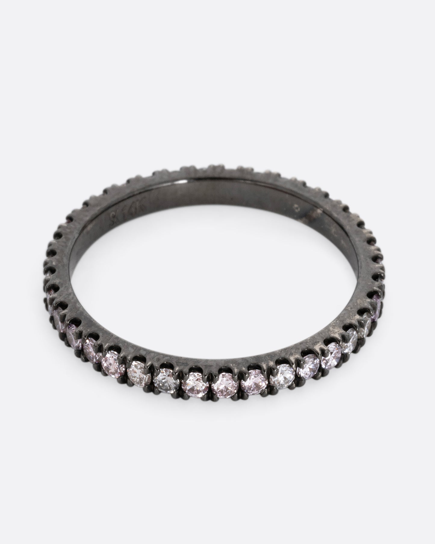 A white gold rhodium plated eternity band with pink, gray, and white diamonds. Shown from the front.