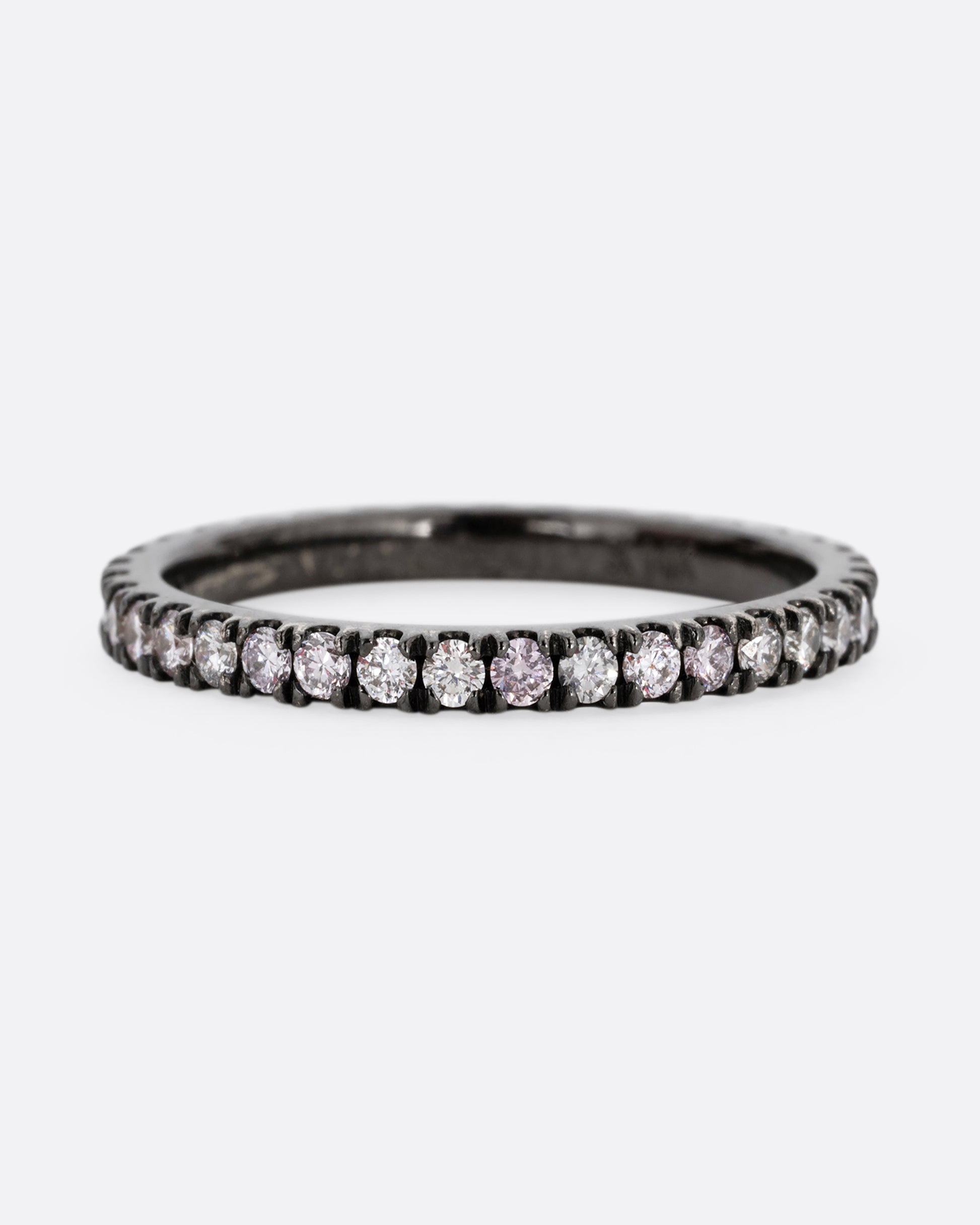 A white gold rhodium plated eternity band with pink, gray, and white diamonds. Shown from the front.