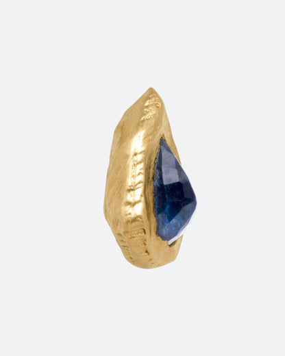Yellow gold blue sapphire teardrop stud earrings, close side view of one stud