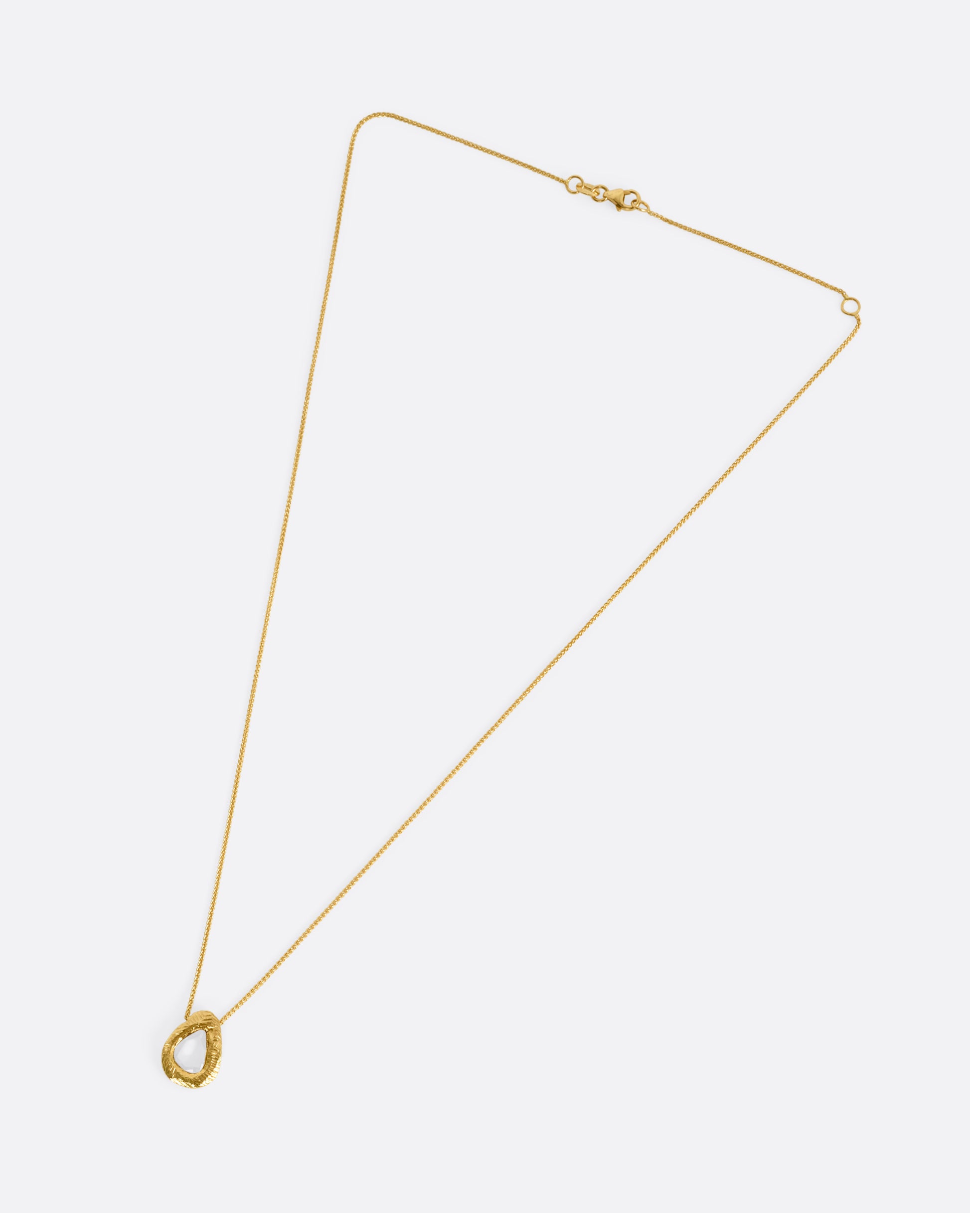 A yellow gold necklace with a yellow sapphire pendant, shown from the front.