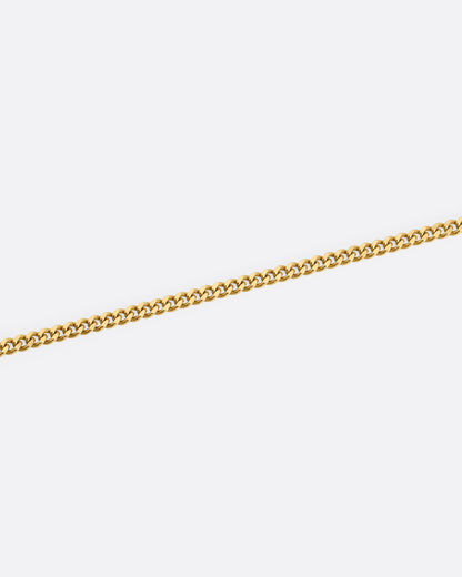 A close up of a yellow gold cable chain.