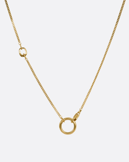 A yellow gold cable chain with an asymmetrical side bail and a central knife-edged hoop, both for charms. Shown from the front.