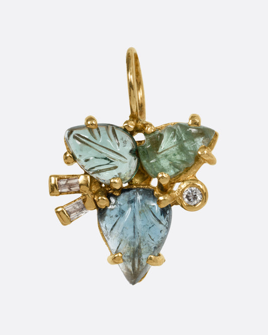 A yellow gold pendant with tourmalines and diamonds, in a botanical shape, shown from the front.