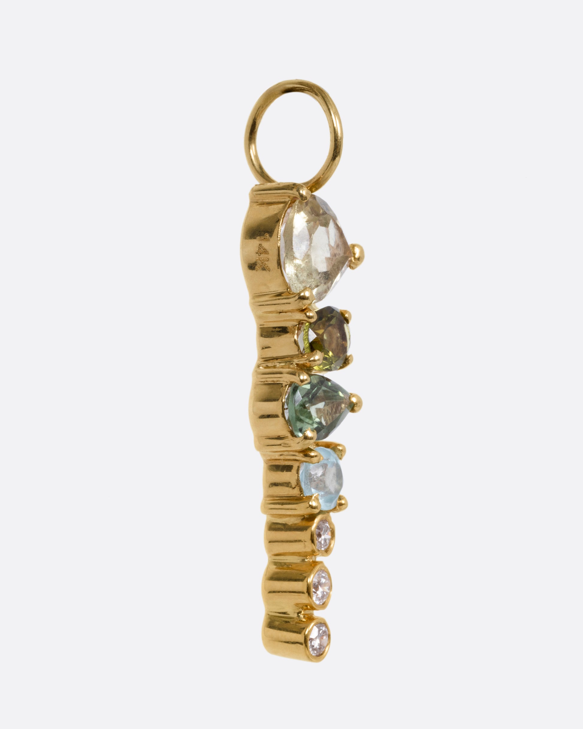 A yellow gold pendant with stacked tourmalines, apatites, sapphires, and diamonds, shown from the side.