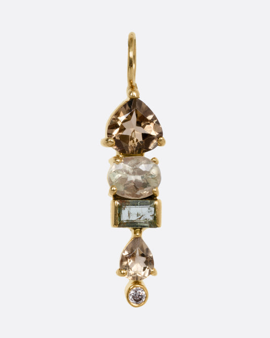 A yellow gold pendant with stacked tourmalines, sapphires, and diamonds, shown from the front.