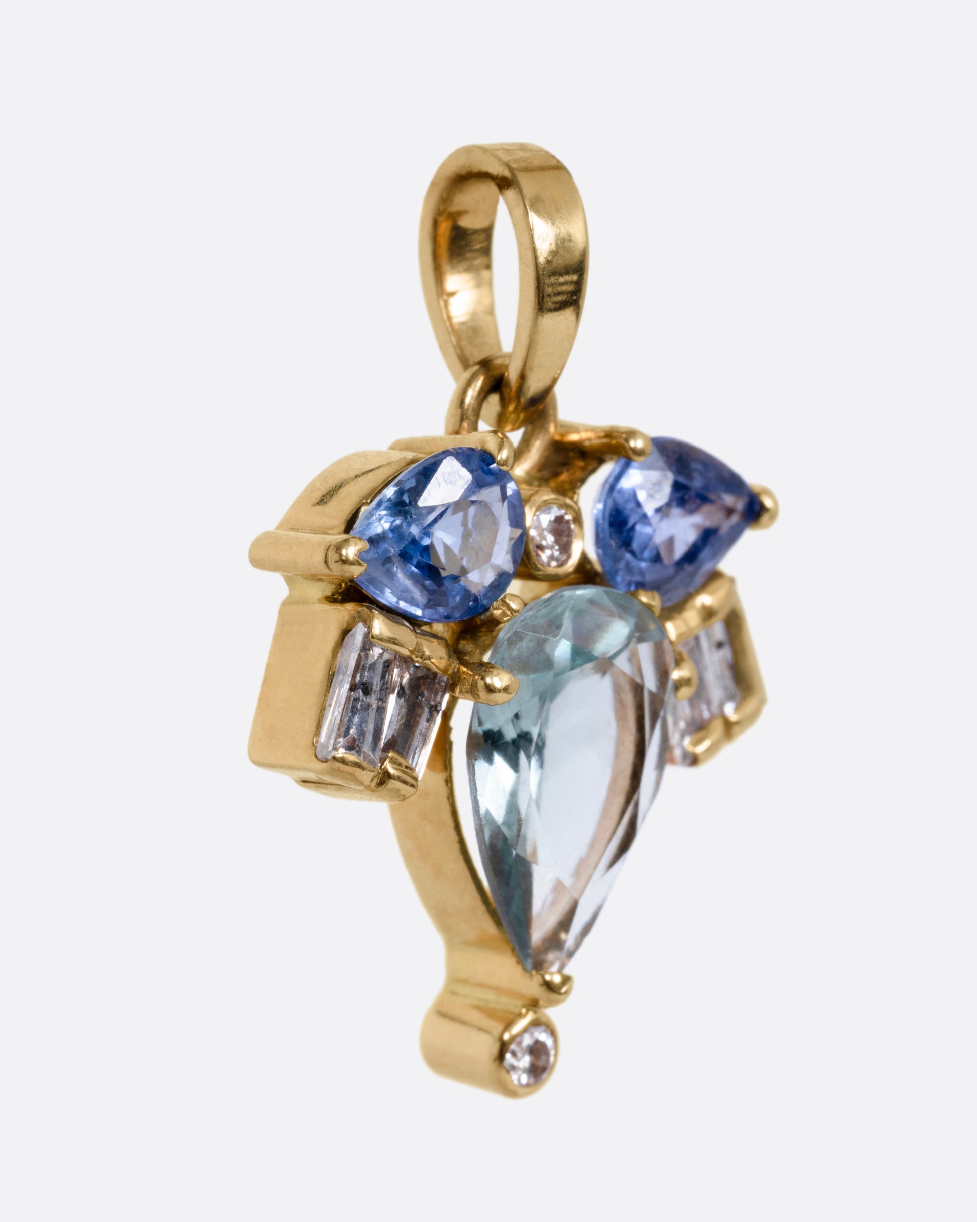 A yellow gold sapphire and diamond pendant in the shape of a firefly, shown from the side.
