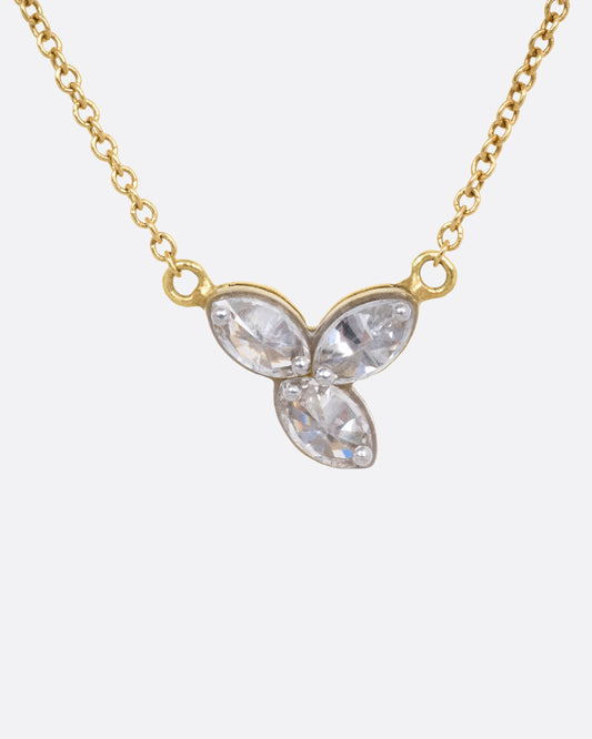 A yellow gold cable chain necklace with a pendant of  three inverted marquise diamonds, shown from the front.