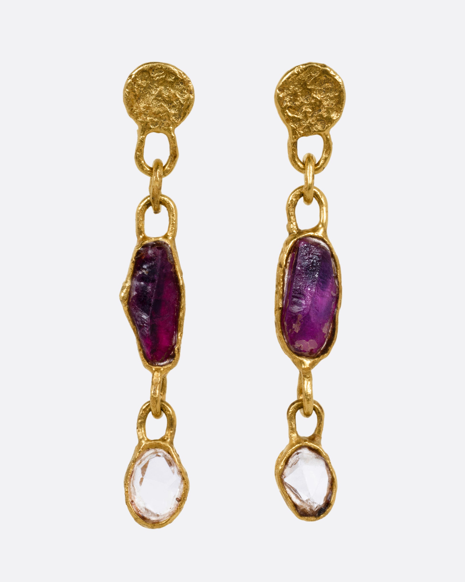 A pair of yellow gold earrings with sapphires and diamonds, shown from the front.