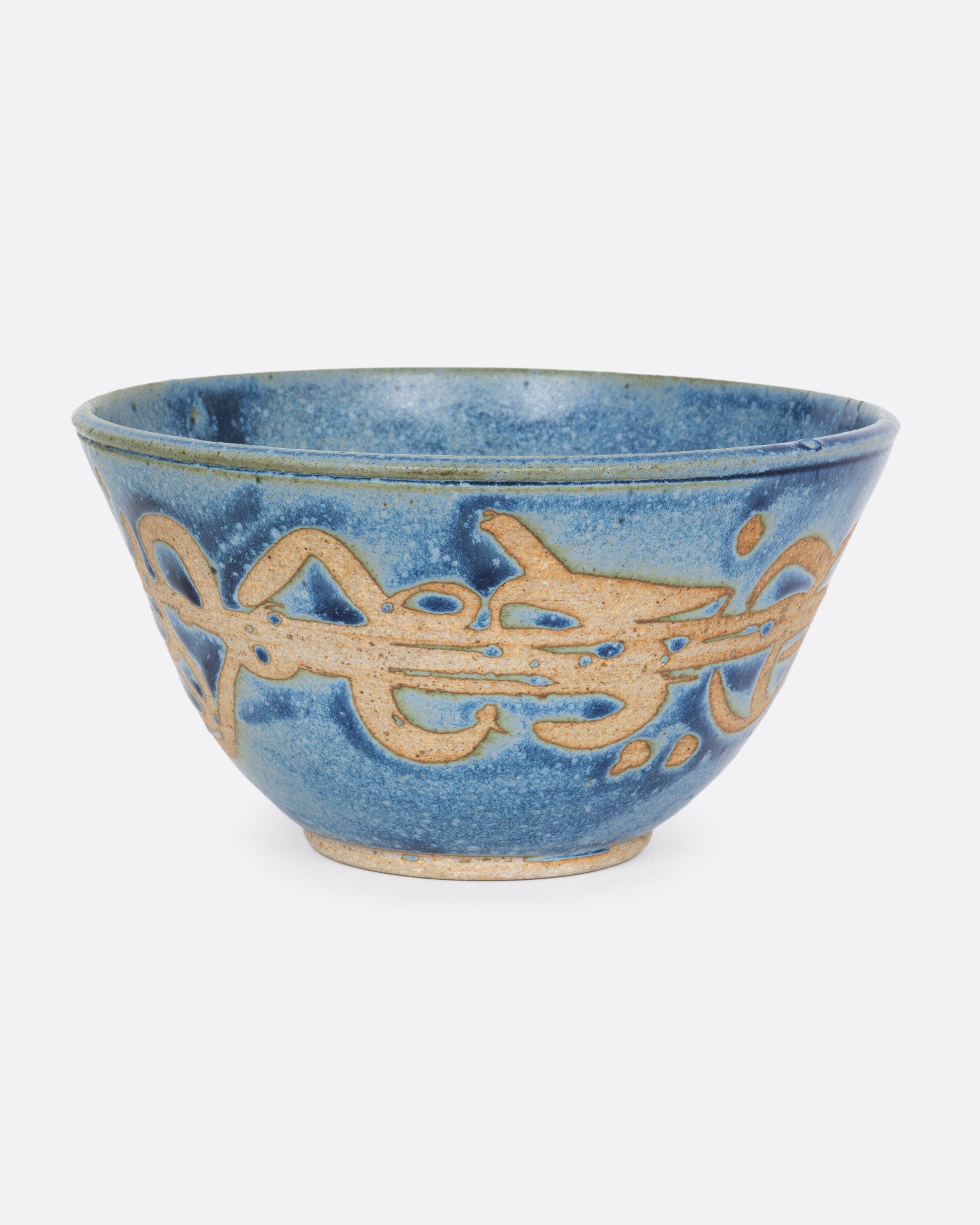 A blue ceramic bowl with brown squiggles around its middle. Shown from the front.