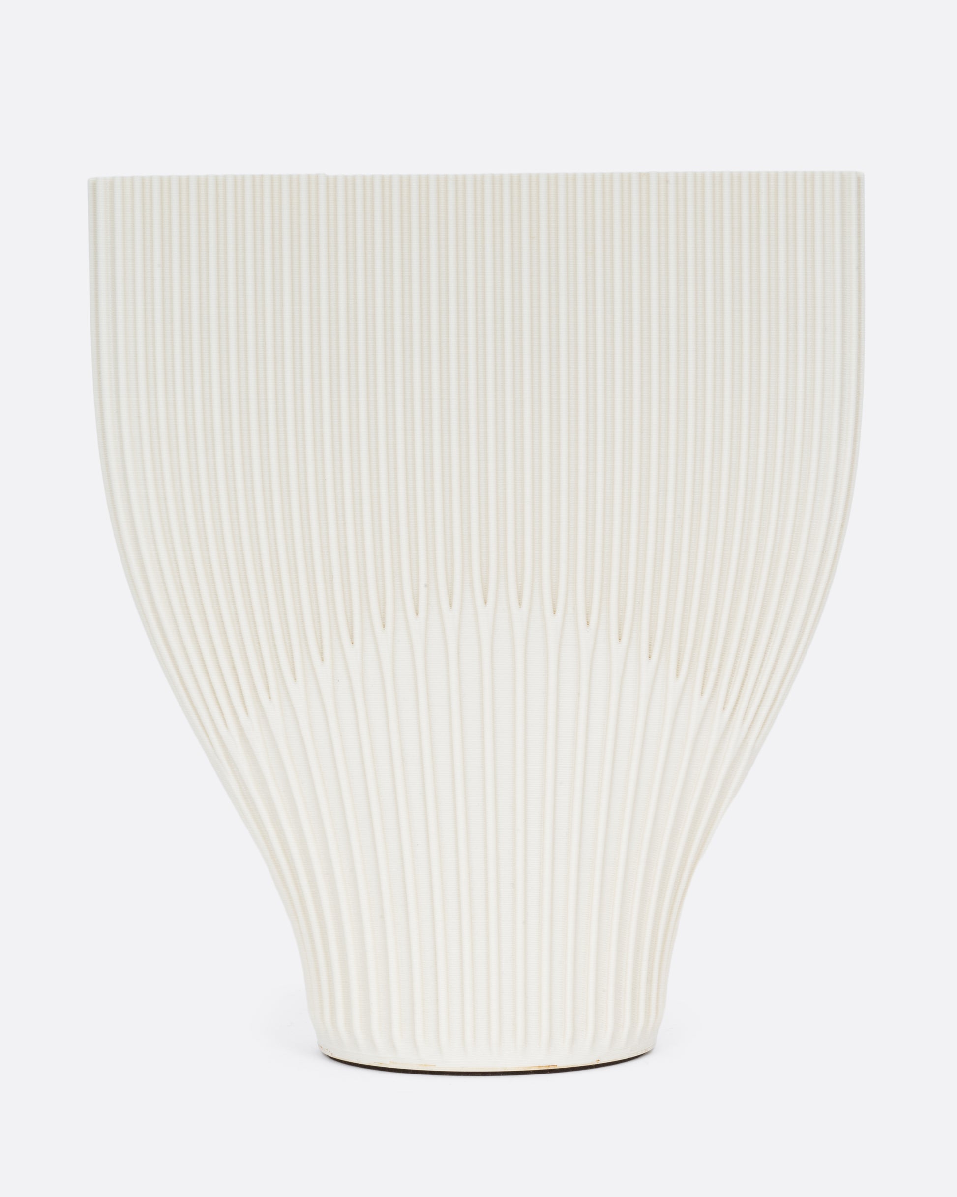  A ribbed cream 3D printed vase with a wide top and narrow base. Shown from the front.