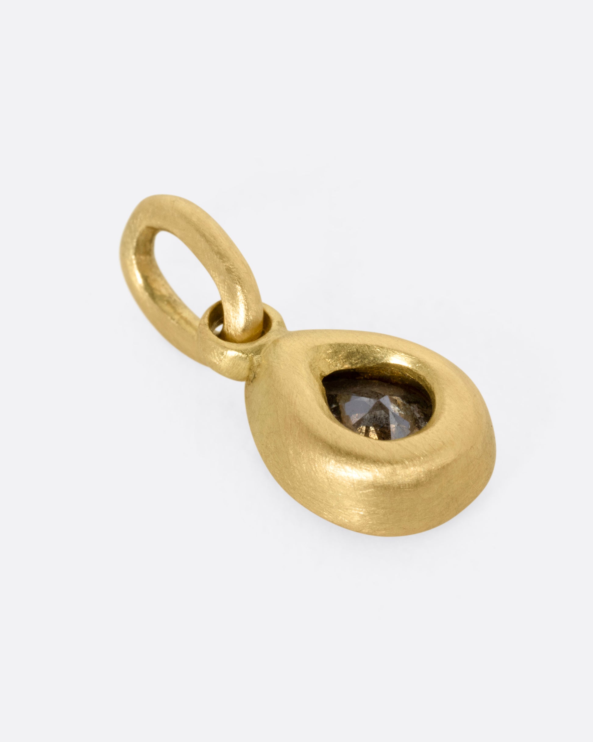 A yellow gold pendant with a pear shaped grey diamond, shown from the back.