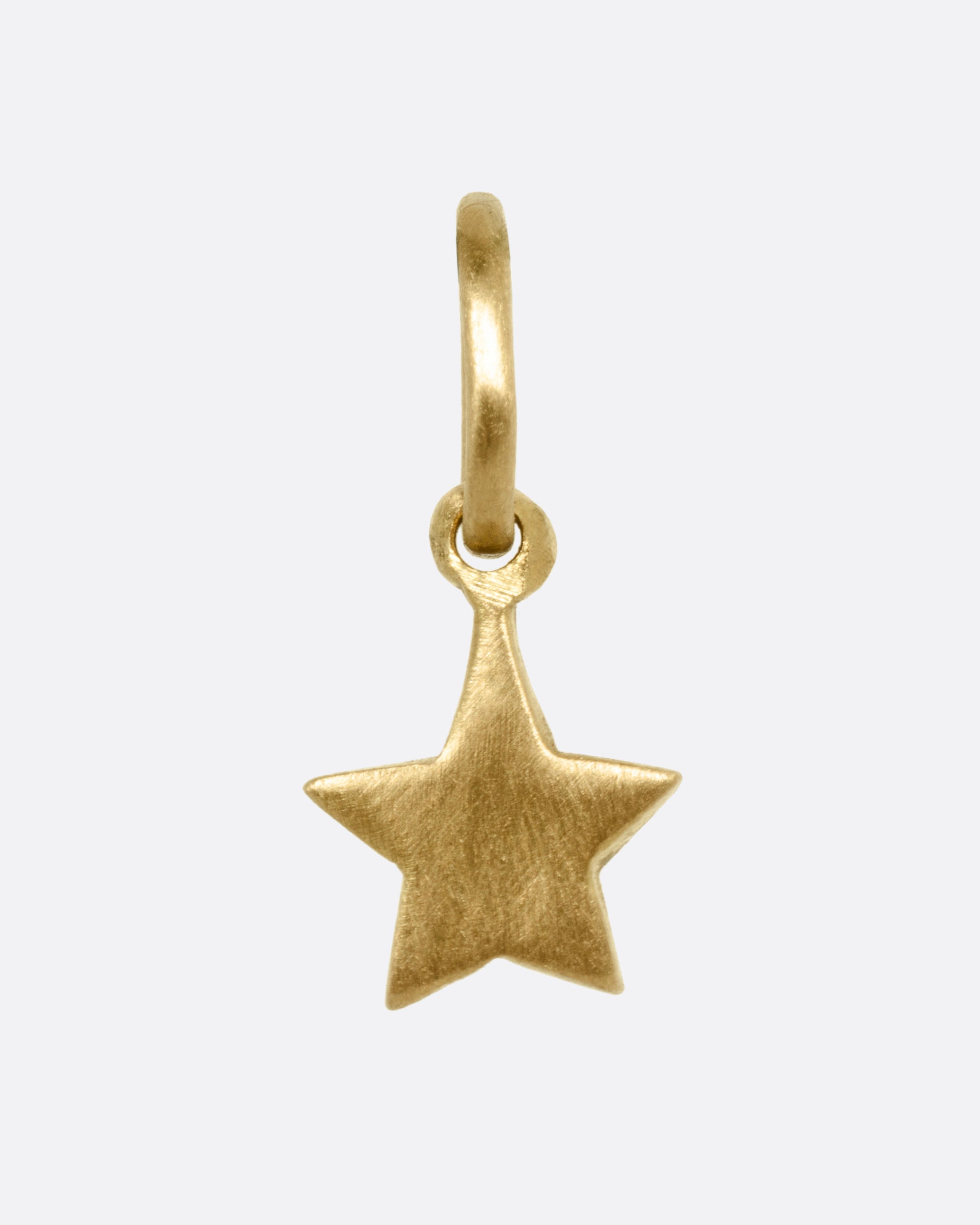 A yellow gold star shaped pendant shown from the front.