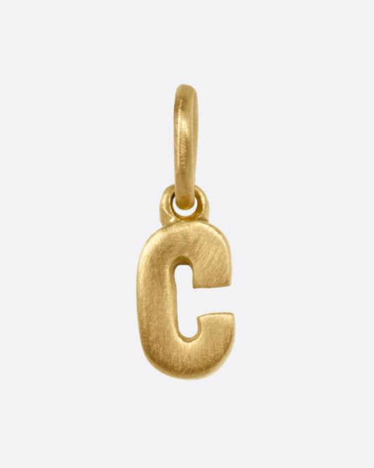 A yellow gold letter 'C' pendant shown from the front.