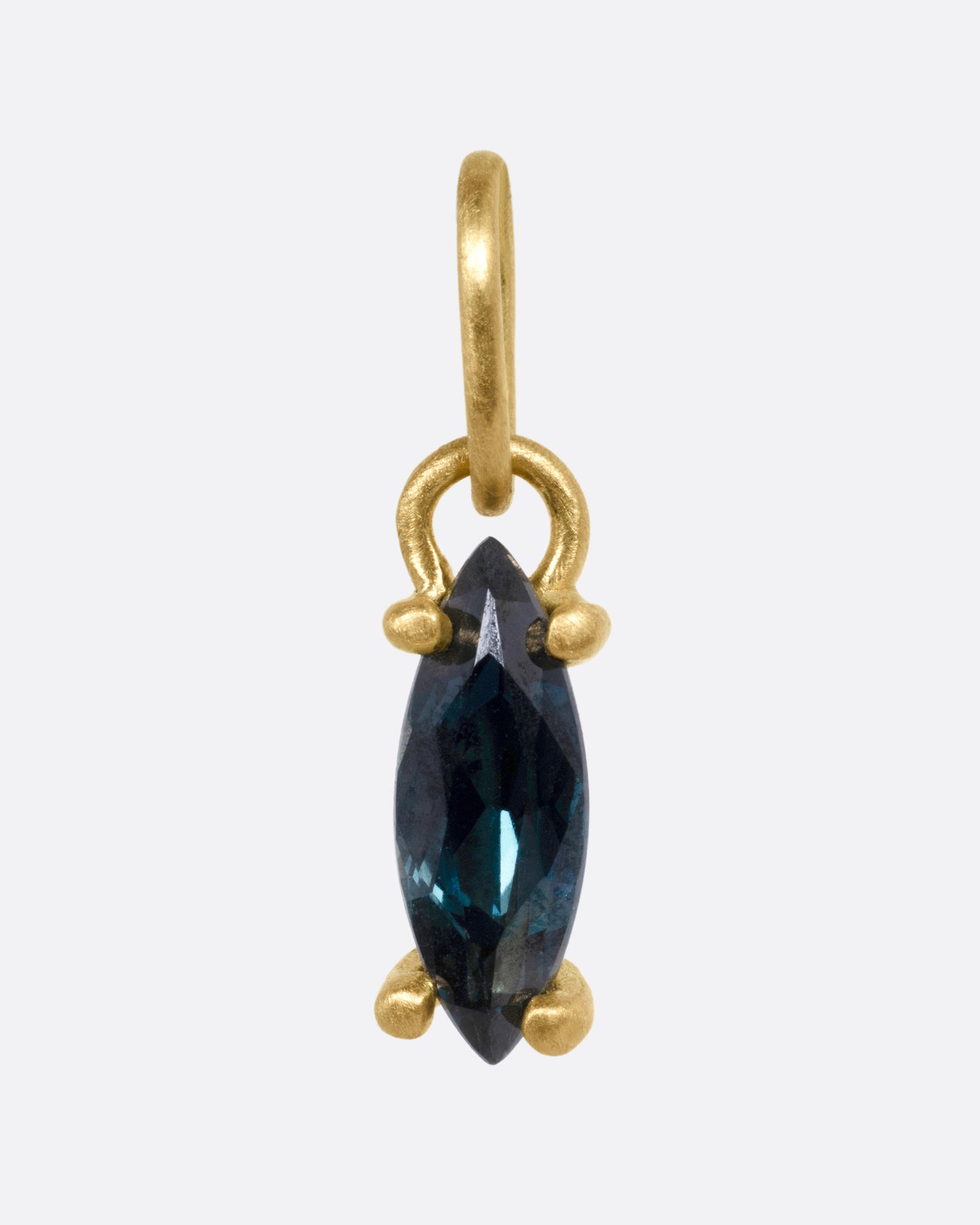 A yellow gold pendant with a blue marquise sapphire, shown from the front.