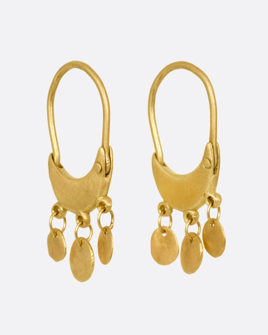 A pair of yellow gold chandelier hoop earrings shown from the side.