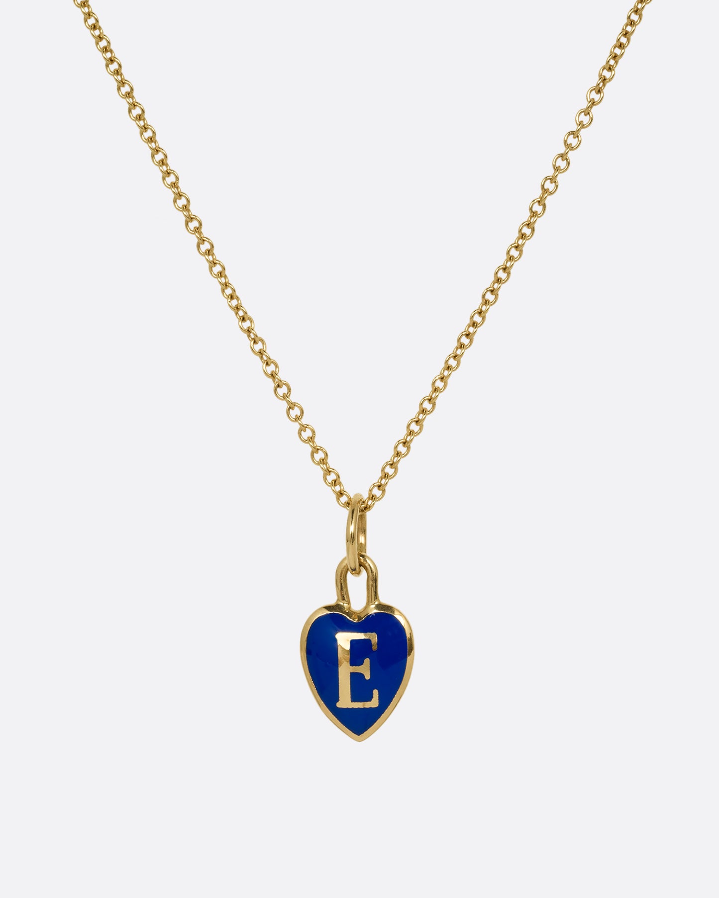 A yellow gold cable chain necklace with a blue enamel heart with a letter E at its center. Shown from the front.
