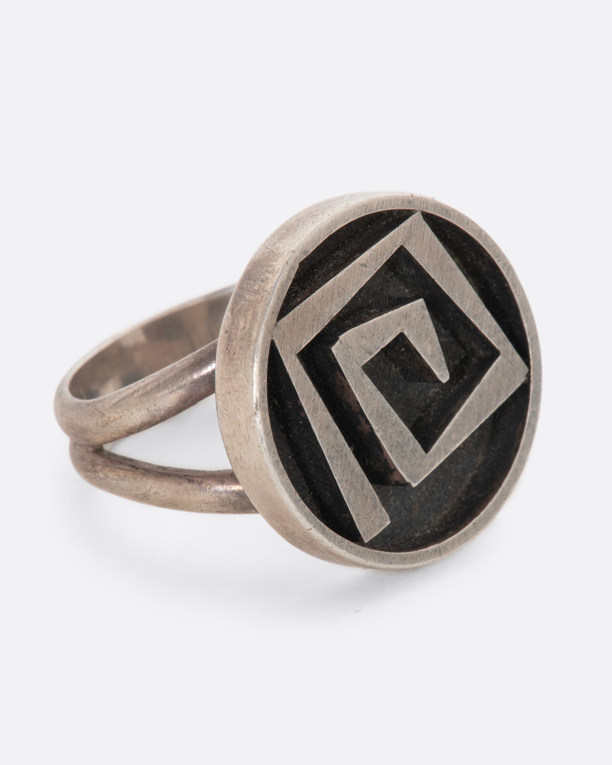 Circular sterling ring with a 3D geometric spiral. View from the right side.