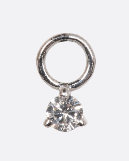 A dangle with a white gold prong setting and jump ring and a white diamond. Shown from the front.