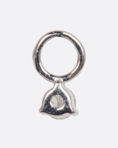 A dangle with a white gold prong setting and jump ring and a white diamond. Shown from the back.
