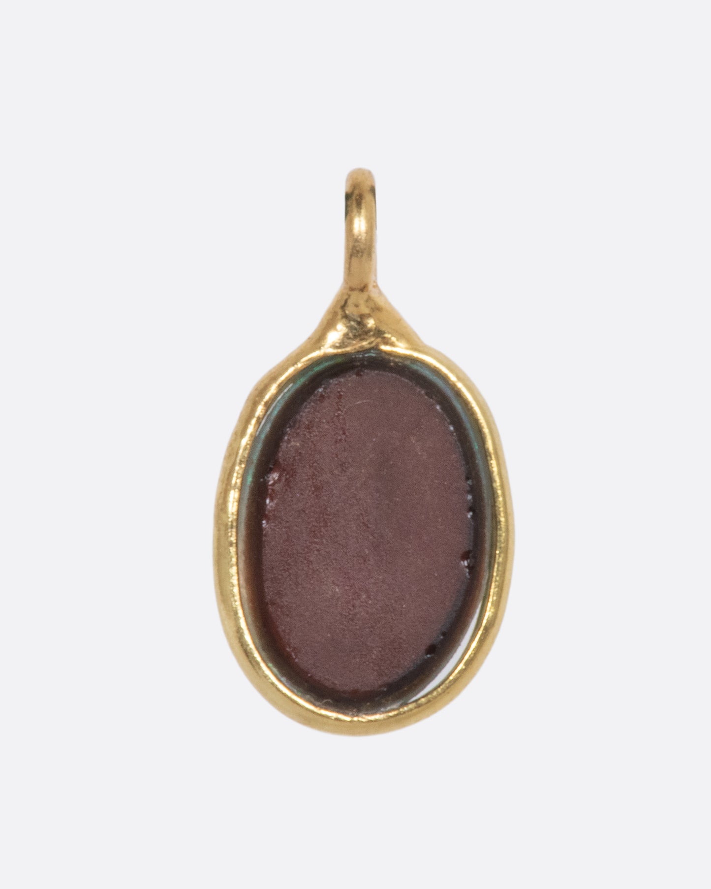 The backside of an Australian opal dangle set in yellow gold. 