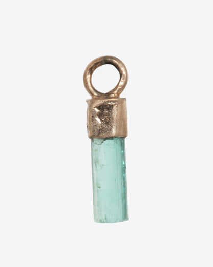 A Colombian emerald dangle in a yellow gold bail. Shown from the back.