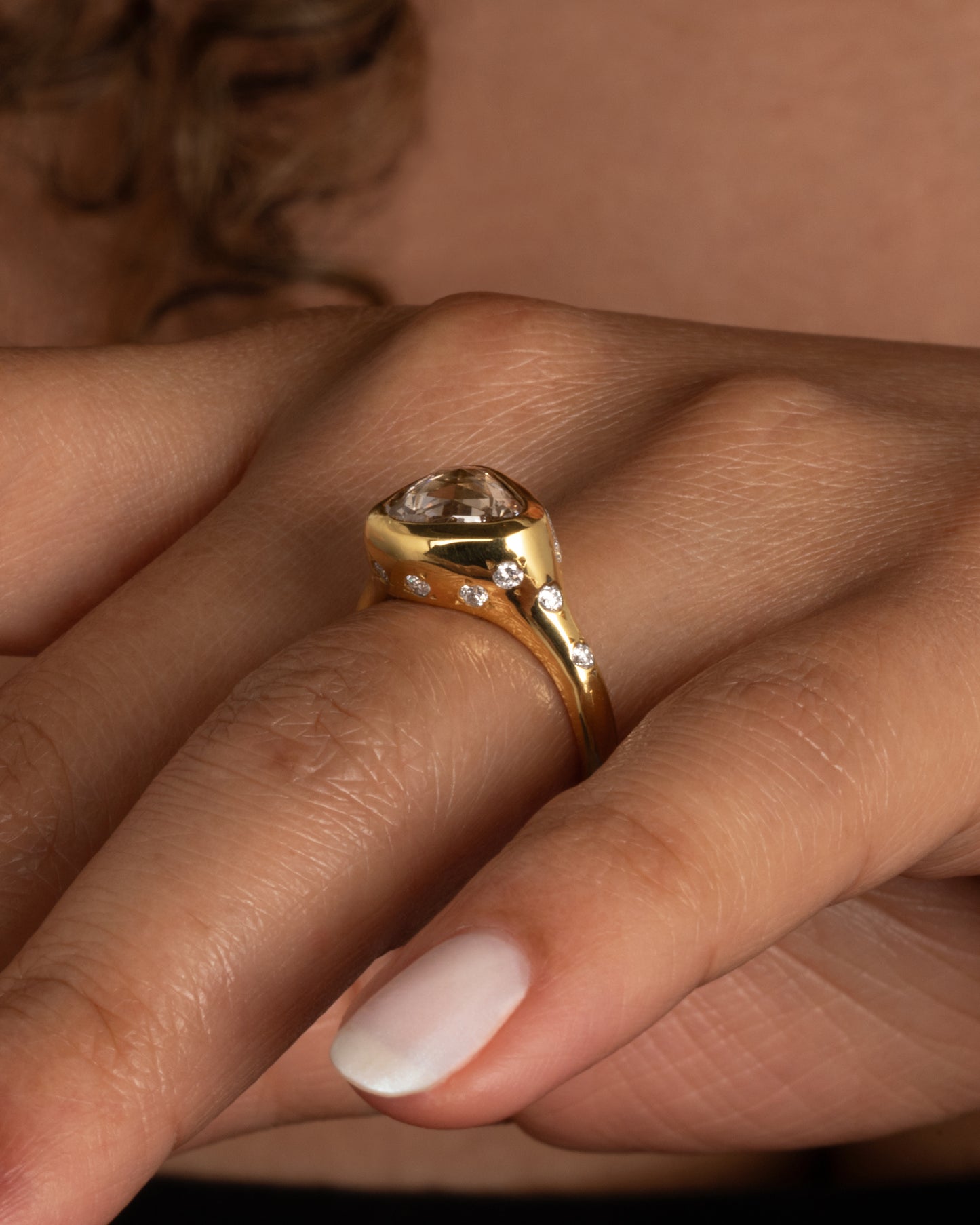 A glorious triangular, rose cut diamond sits on its side giving this ring an east-west sensibility. Shown worn on a finger.