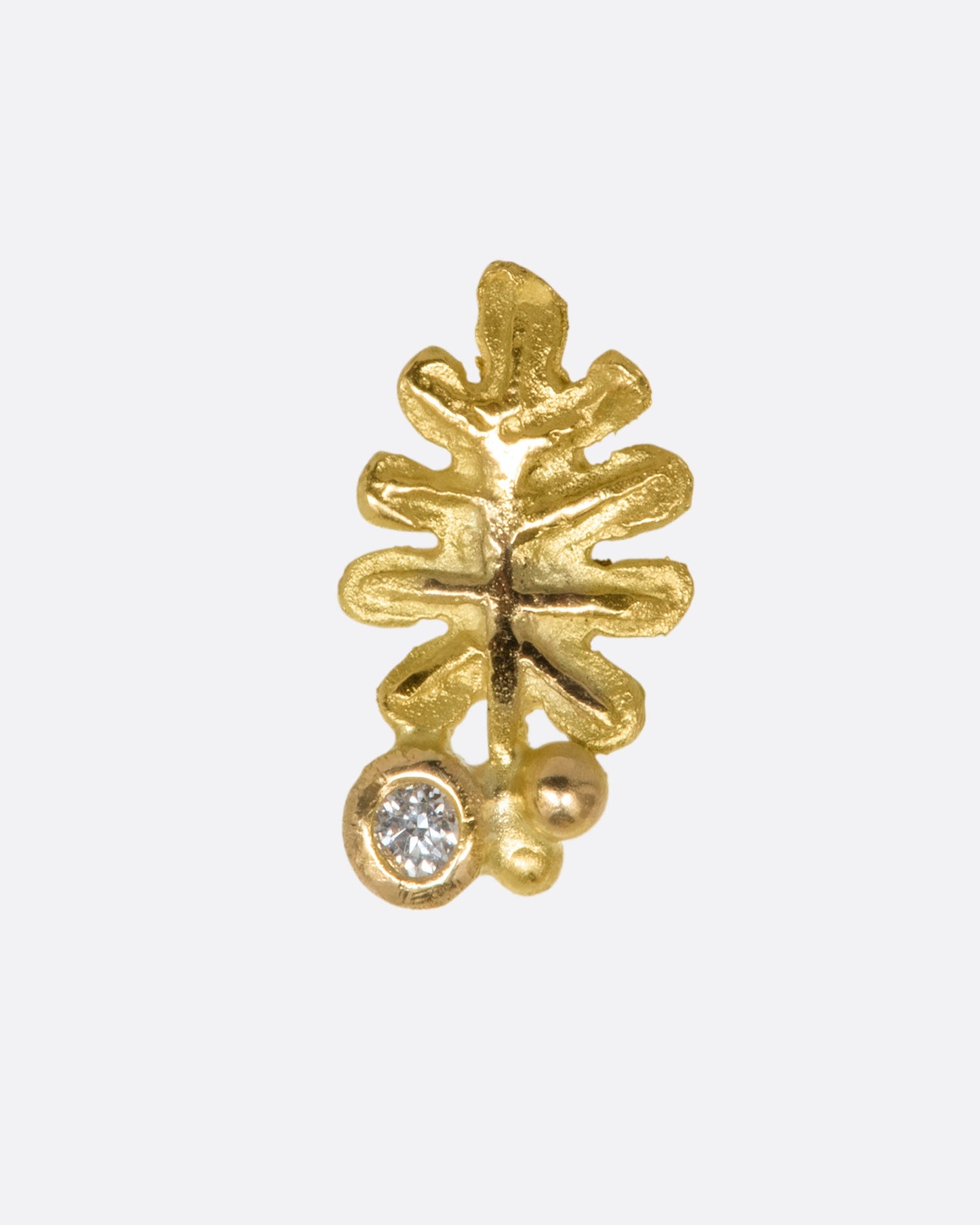 A yellow gold oak leaf earring with a diamond at the stem. View from the front. 