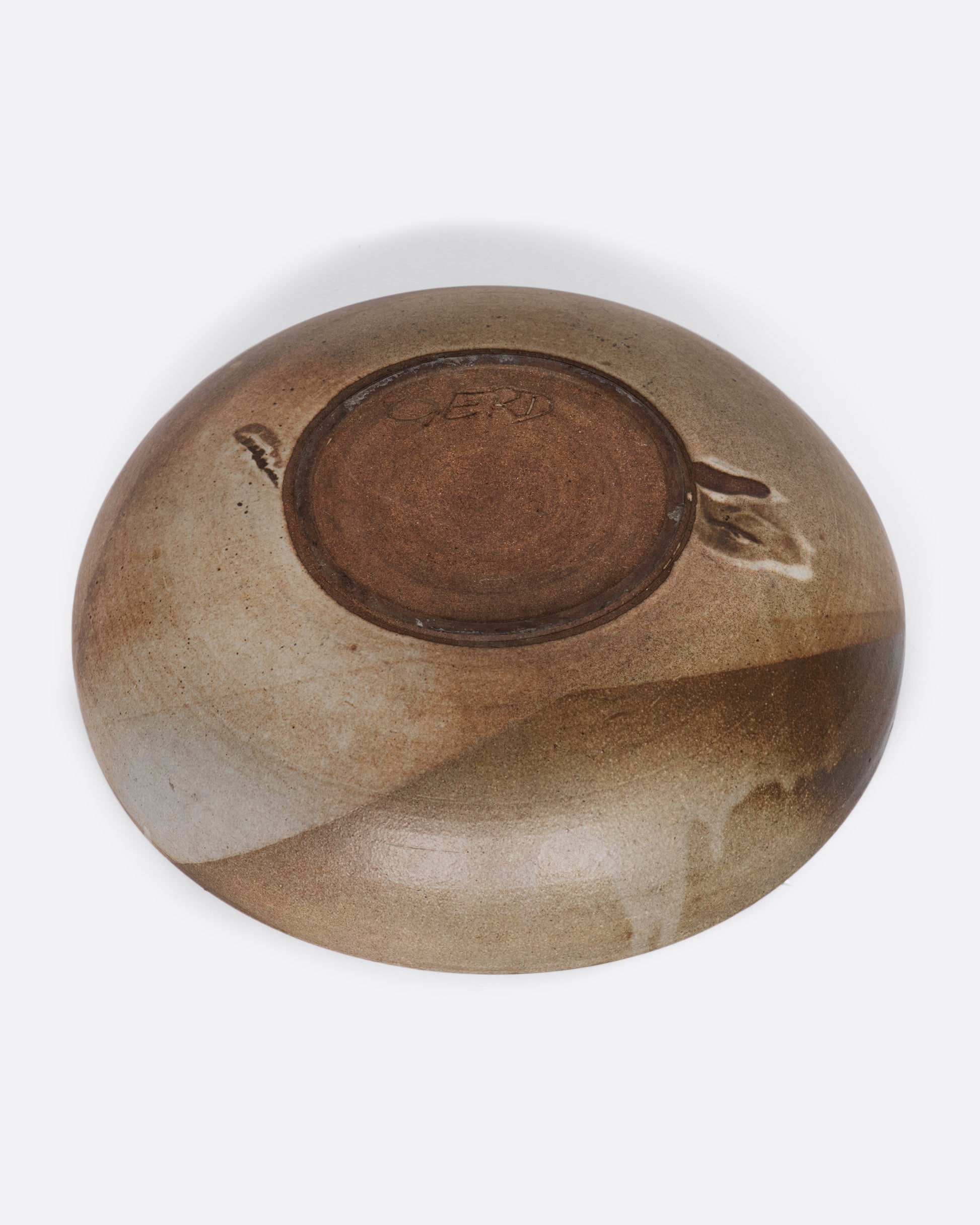 A ceramic deep bowl platter with painted abstract design on the interior. View of the signature on the underside.