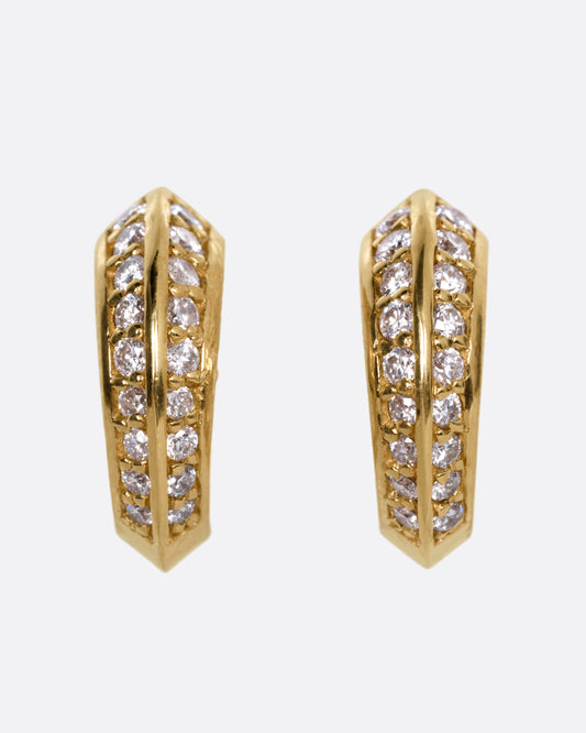 A pair of yellow gold hoop earrings with diamonds, shown from the front.