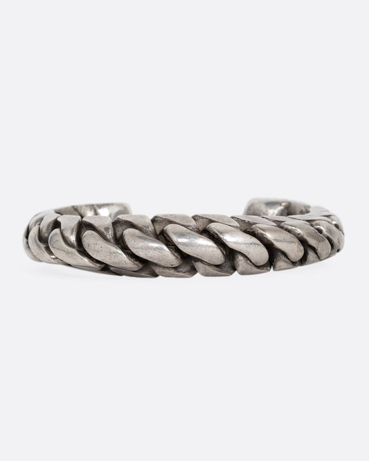 A silver curb chain cuff bracelet, soldered stiff with an open back. Shown from the front.