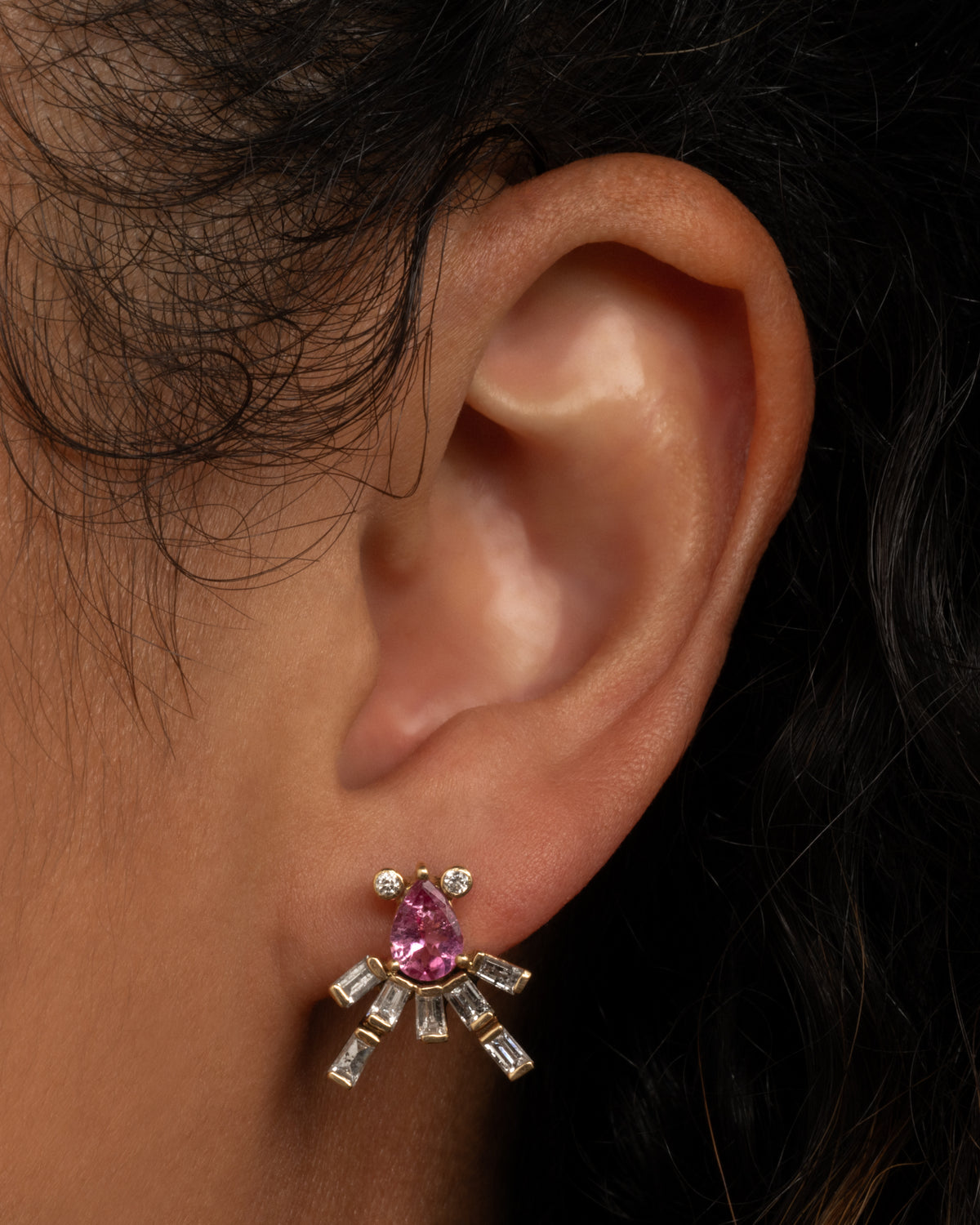 Yellow gold tanzanite and diamond octopus stud earring, an Octopus stud shown on an ear for scale, in a pink stone version