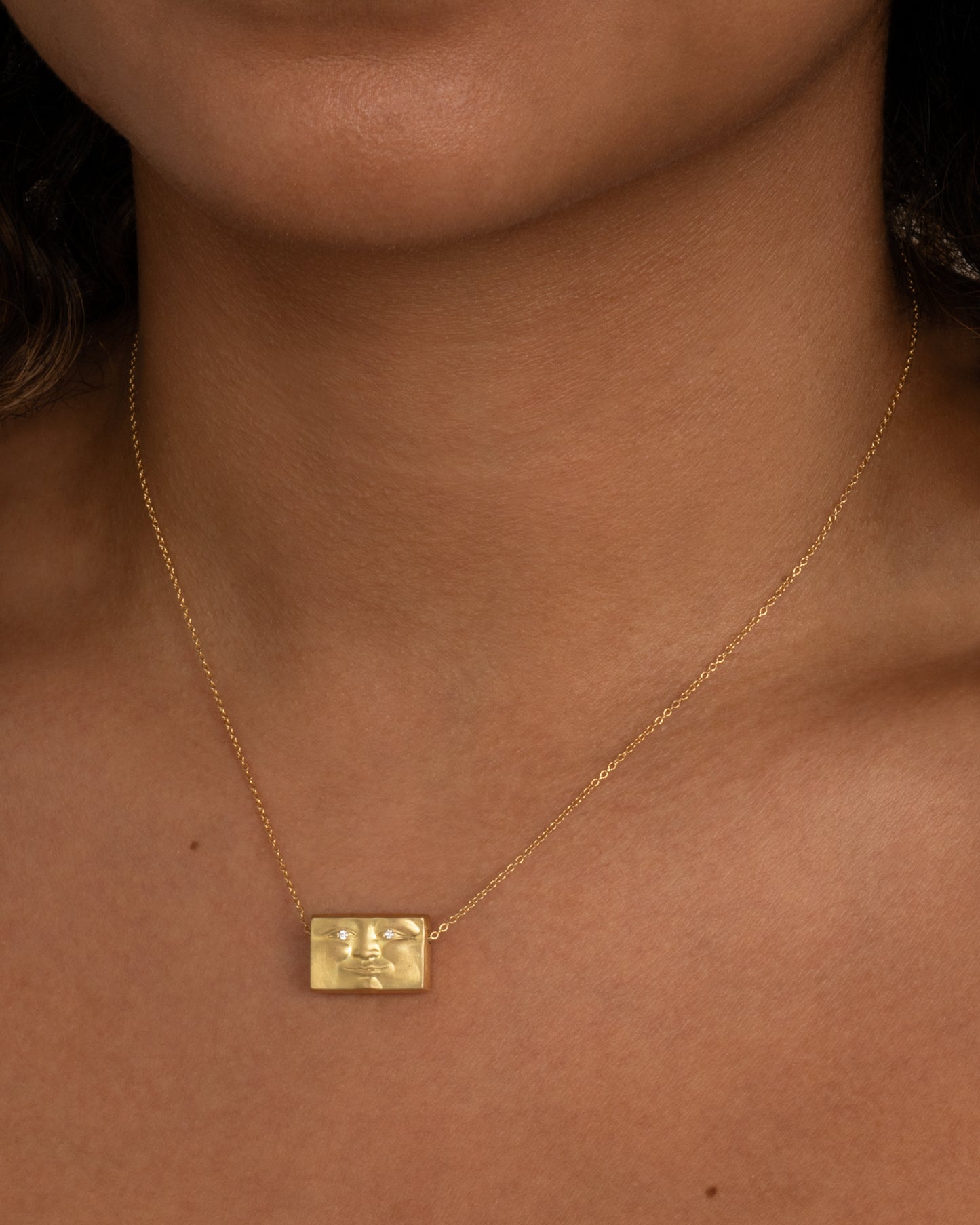 The golden mean is a proportion famous since antiquity for being aesthetically pleasing, and is the basis of Anthony Lent's Brickface, which aims to evoke strength and solidity. Shown worn around a neck.