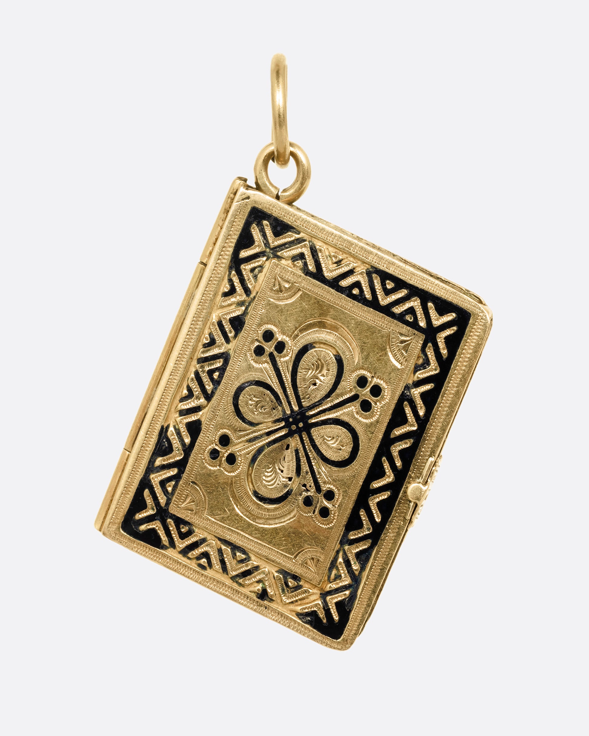 A yellow gold album locket with enamel detailing. It hangs at an angle and is shown from the front. 