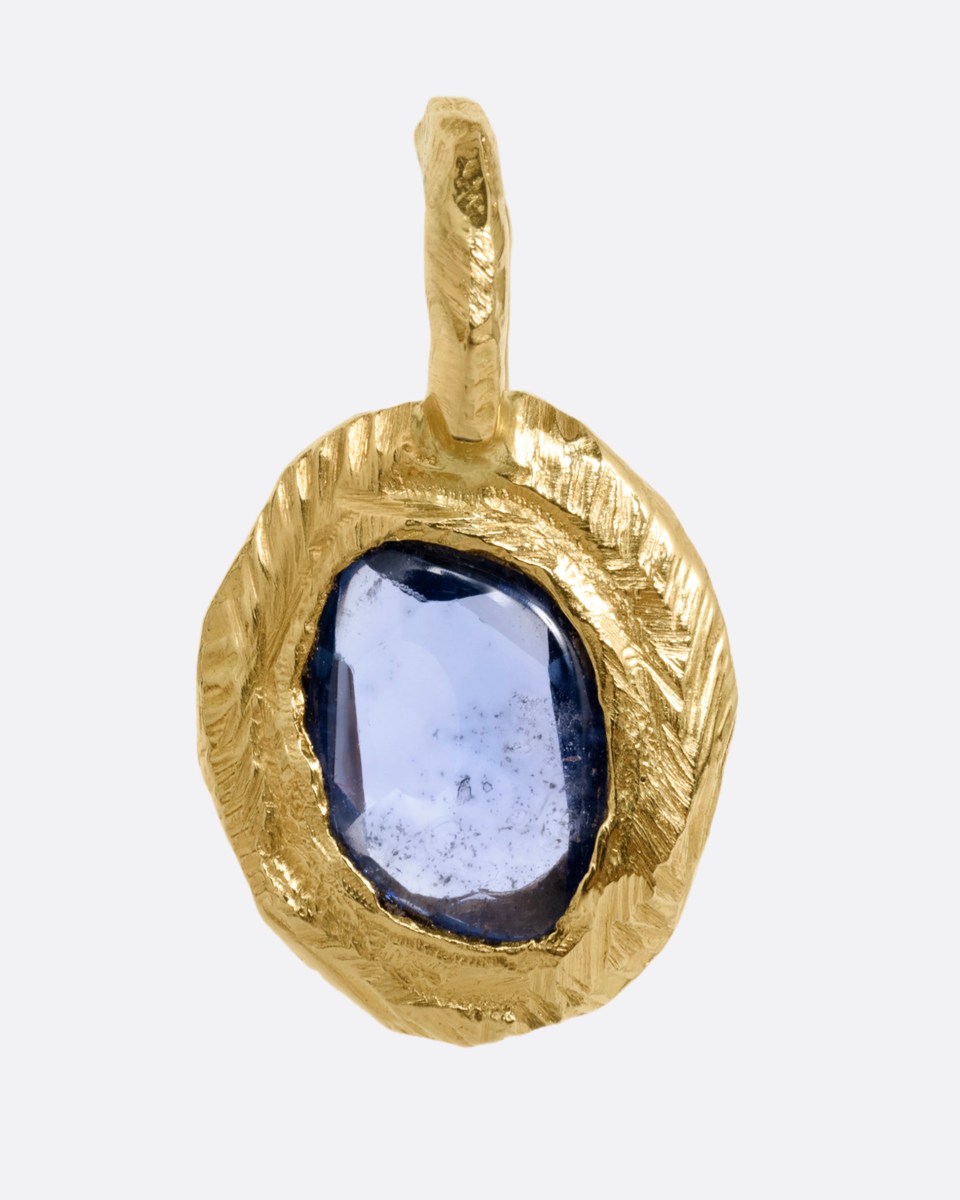 A yellow gold pendant with a blue sapphire, shown from the front.
