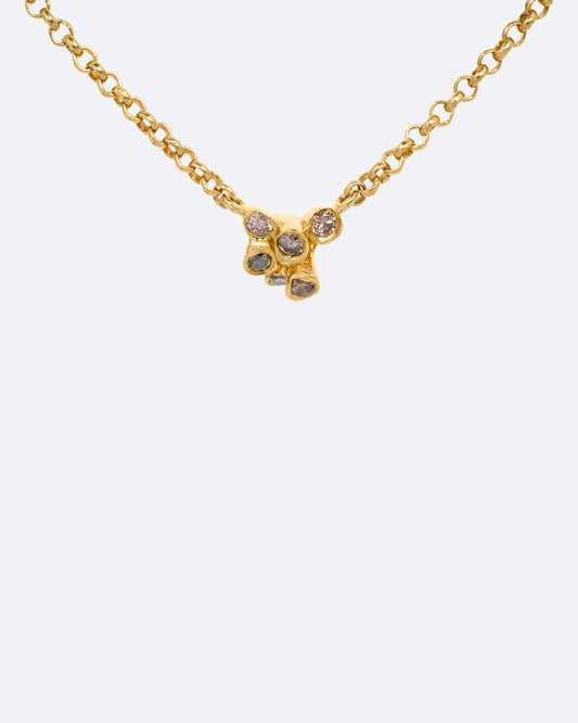 A yellow gold cable chain necklace with a central cluster of dimensional cognac diamonds. Shown from the front.