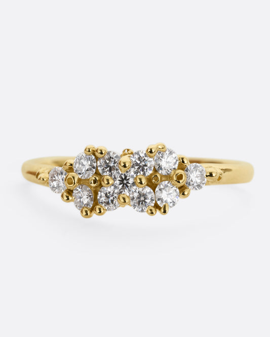 A yellow gold ring with a large cluster of diamonds and tiny gold droplets. Shown from the front.