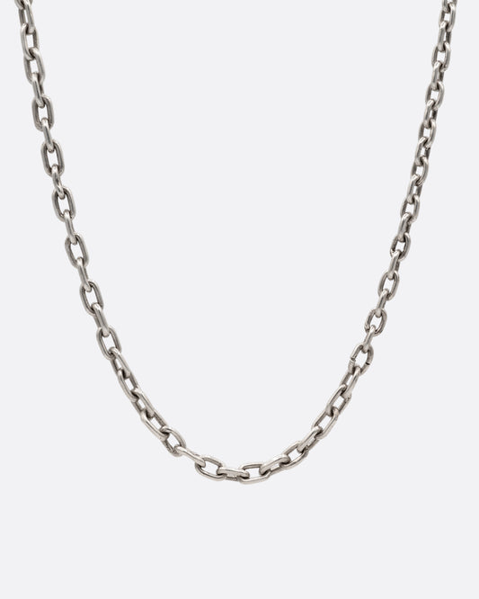 A long silver cable chain shown from the front.
