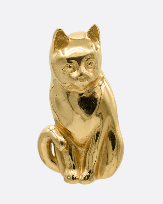A yellow gold cat charm, shown from the front. 