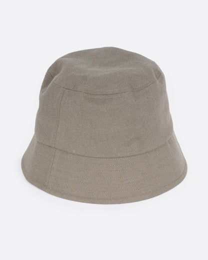 A green bucket hat with a short brim and is made from cotton/ linen blend, shown from the front.
