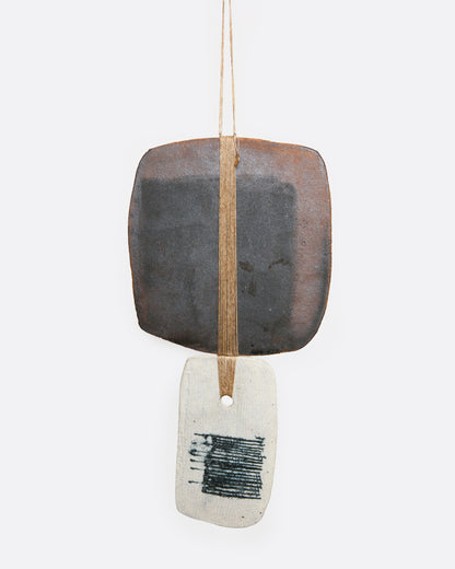 Clay and linen wall hanging, the second piece, a dark clay tile above linen with a blue printed square