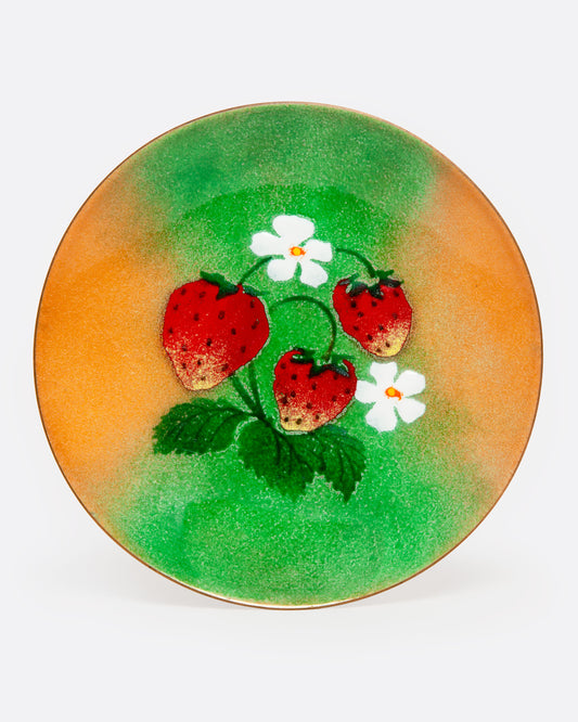 A yellow and green plate with strawberries at the center. Shown from the front.