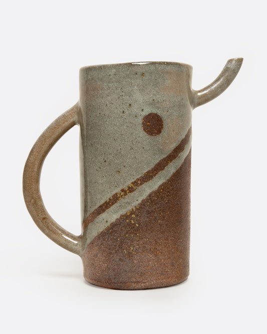 A brown striped ceramic pitcher, shown from the side.