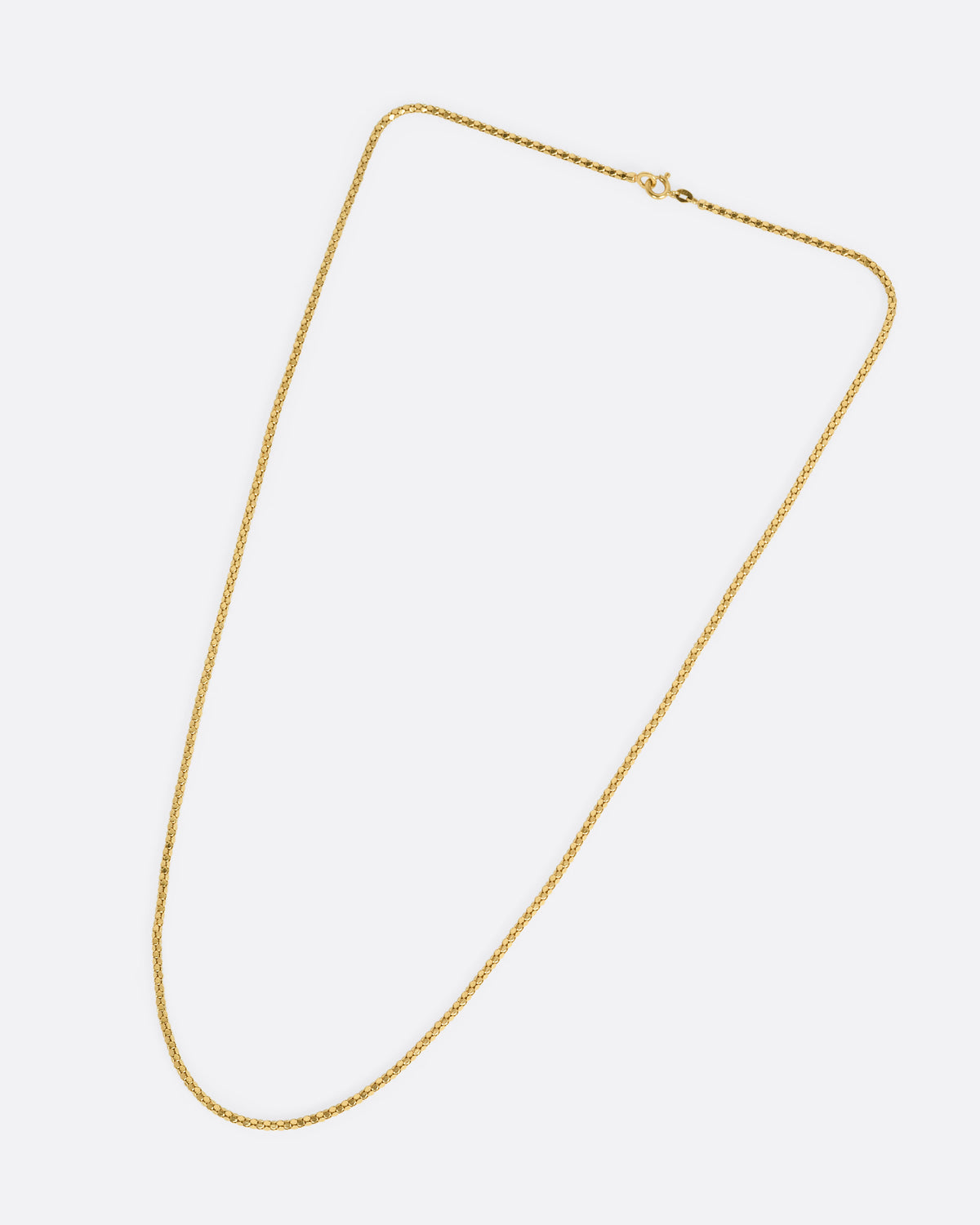 A yellow gold tube chain necklace, shown from the front.