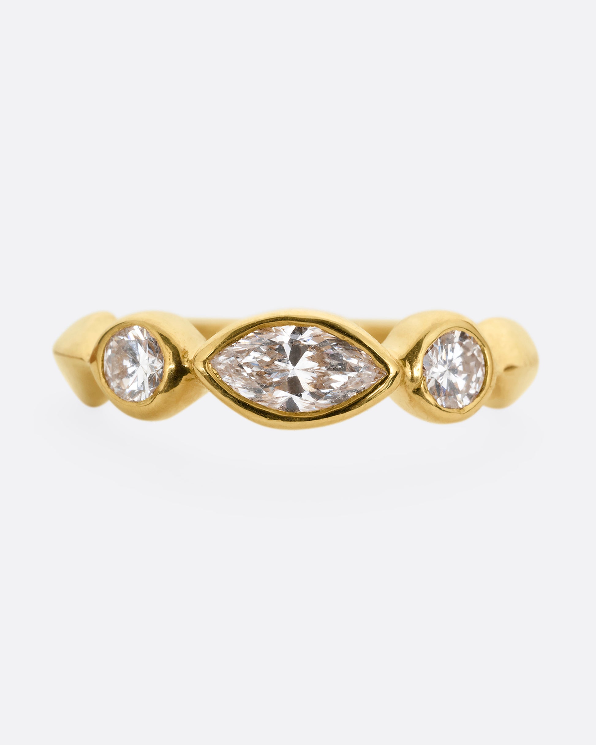 A yellow gold ring with three diamonds shown from the front.