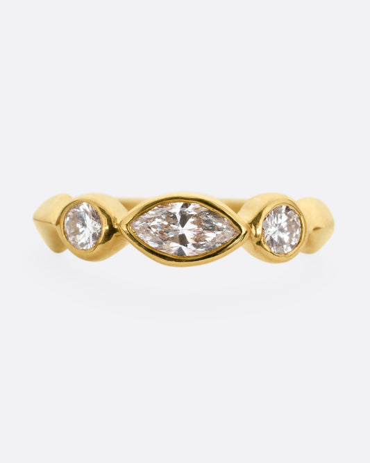 A yellow gold ring with three diamonds shown from the front.