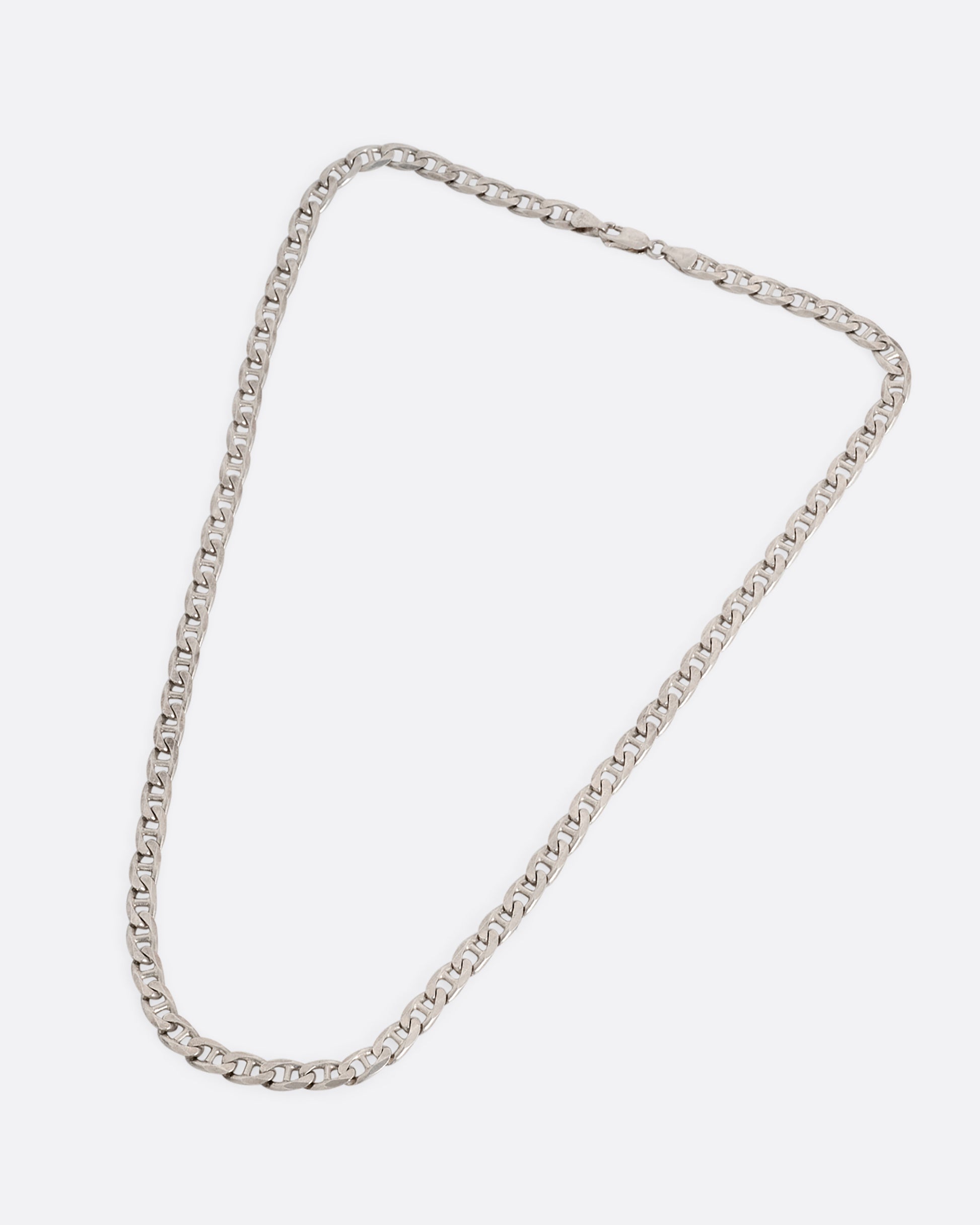 A silver anchor link chain necklace, shown from the front.
