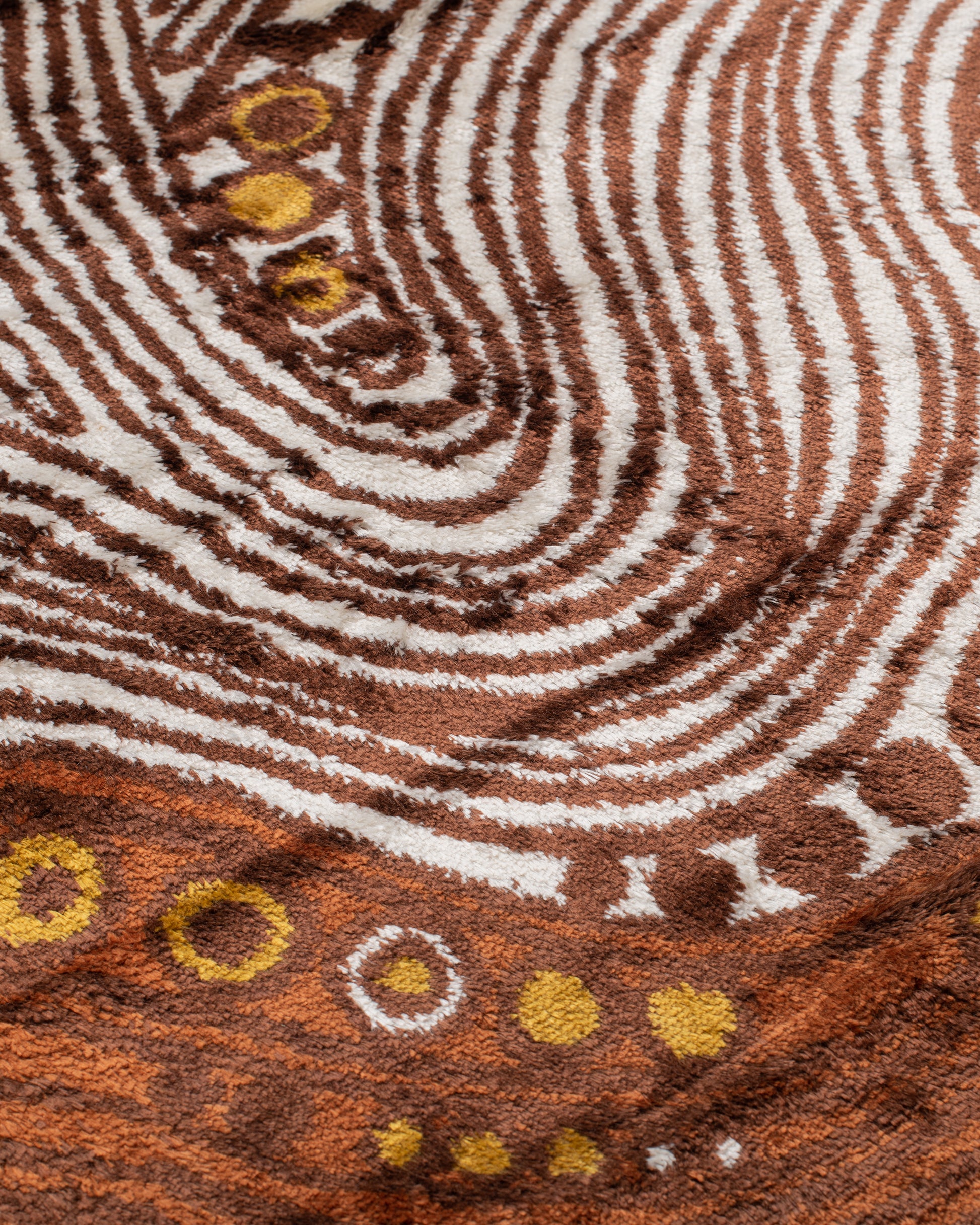 A unique Hungarian mid-century modern rug featuring organic white and brown lines intertwined with an array of orange and brown circles that look like treasures hidden among layers of rock