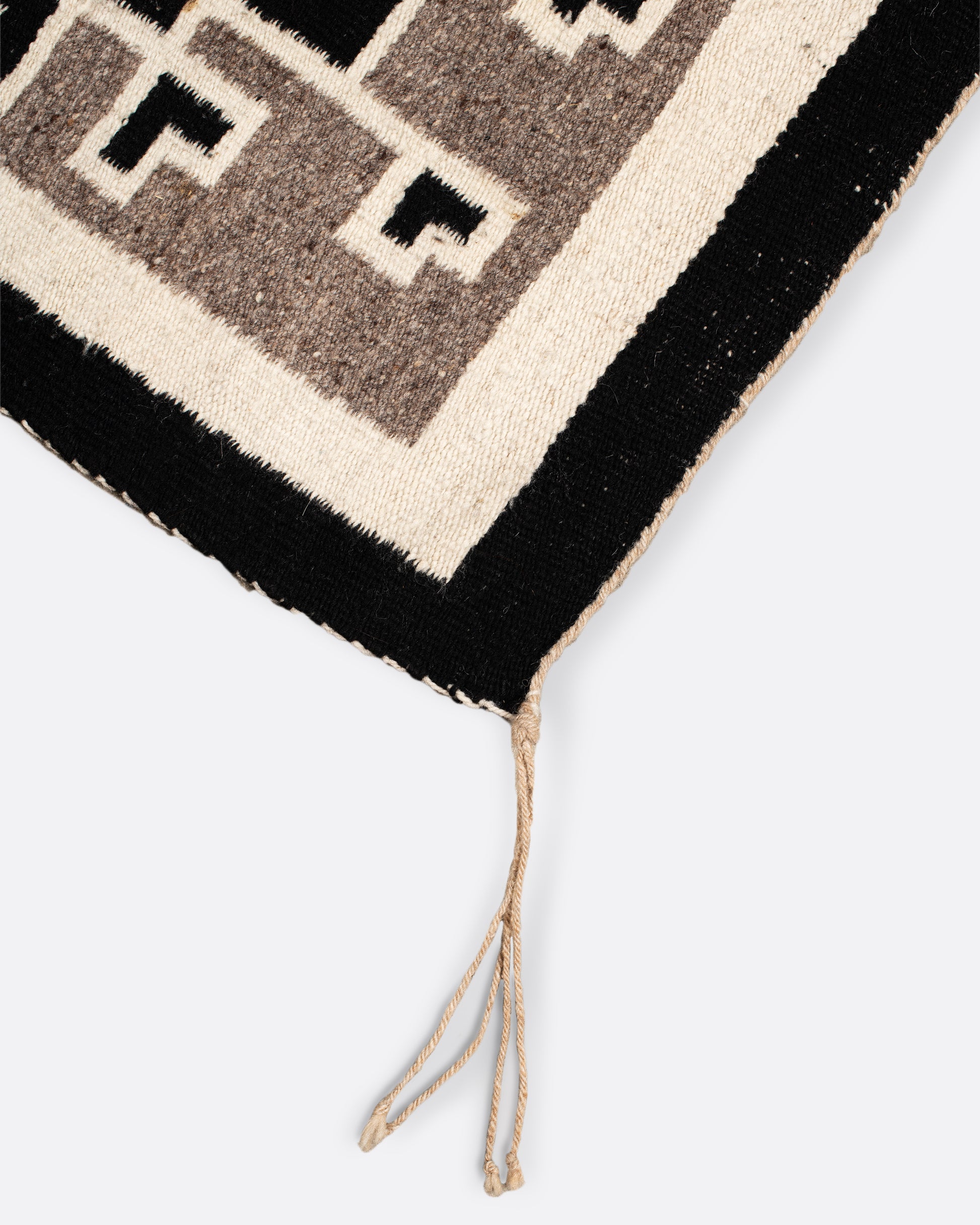 A vintage Navajo rug with the traditional Two Grey Hills weaving